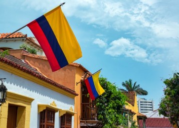 Low Angle View Of Colombian Flags On Houses In City