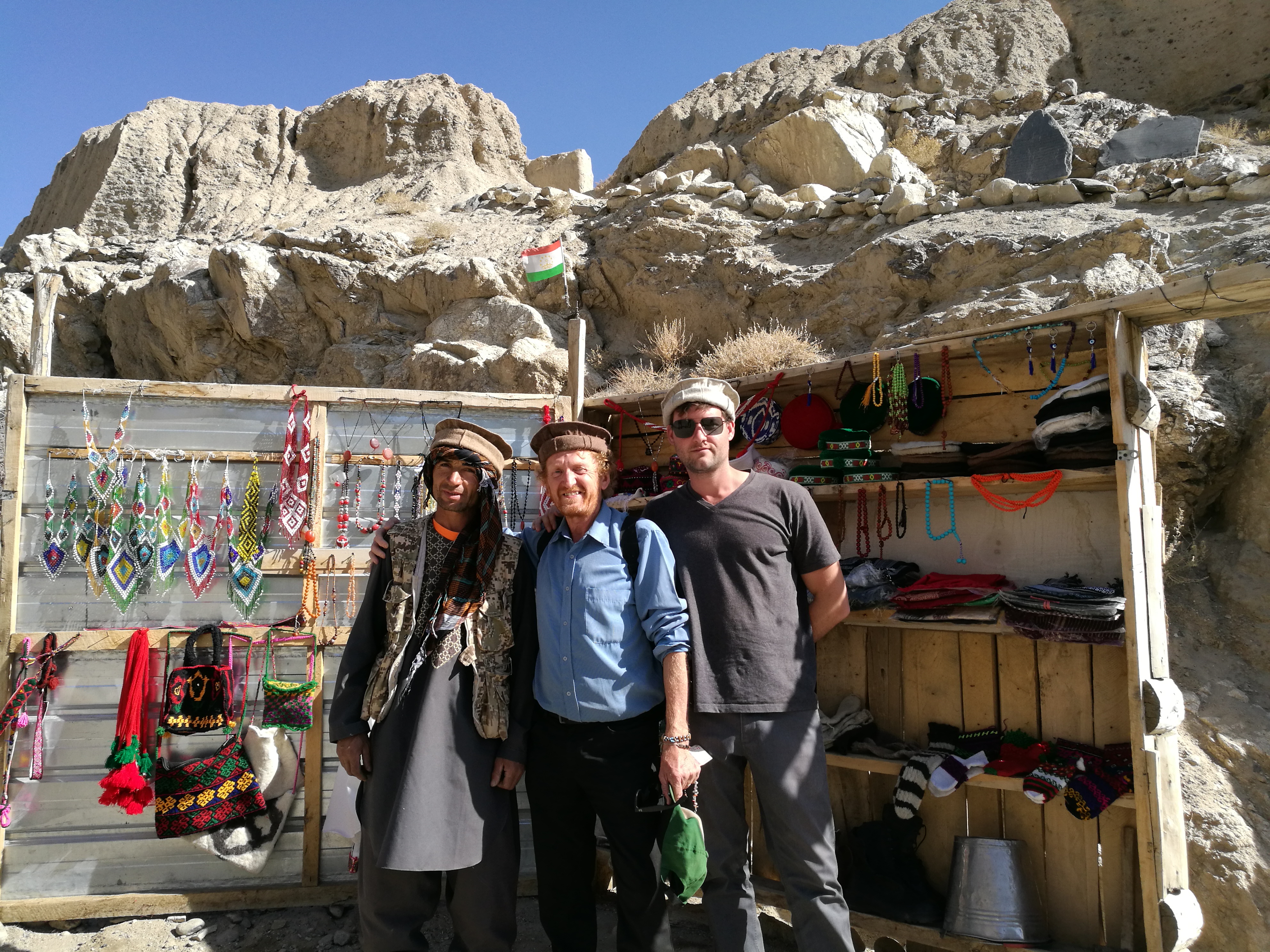 Pamir Highway: YPT guide Troy poses with a Tajik hat vendor along the Pamir Highway.