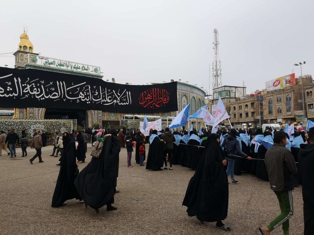 A procession taking place in front of Imam Husayn's Shrine, in Karbala