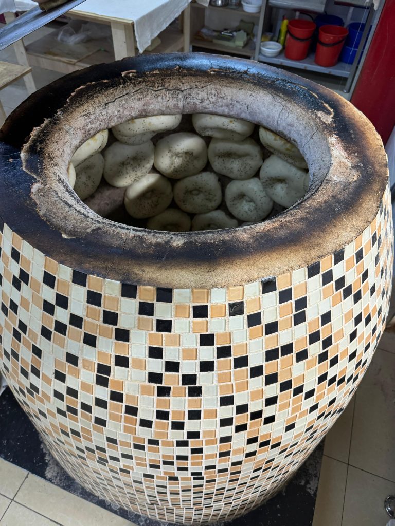 Central Asian Non baking in a traditional tandoor oven. Osh, Kyrgyzstan.