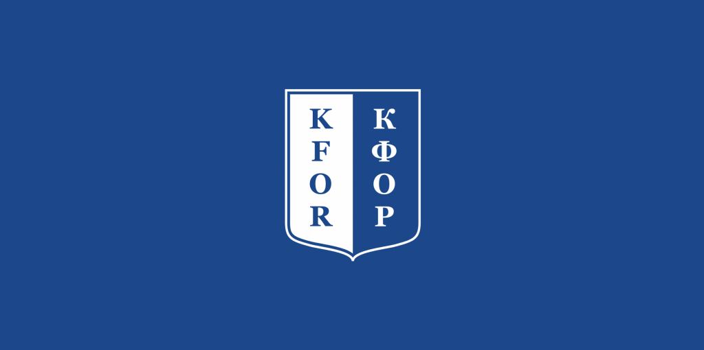 The flag of KFOR (NATO's peacekeeping mission).